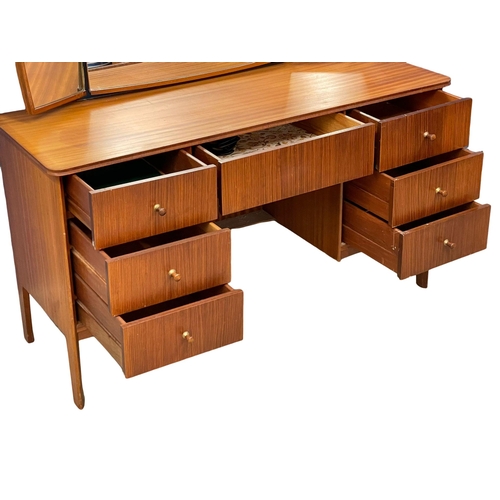 913 - A Mid Century teak dressing table designed by Peter hayward for Vanson. 1960. 133x49x133cm
(3)