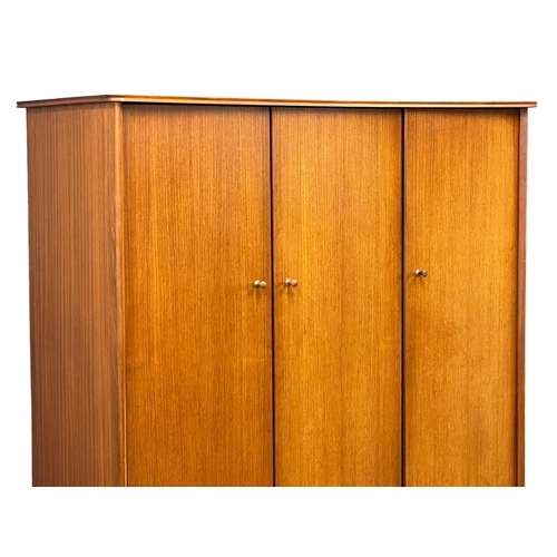 914 - A Mid Century teak 3 door wardrobe designed by Peter hayward for Vanson. 1960. 141x60x184.5cm (3)