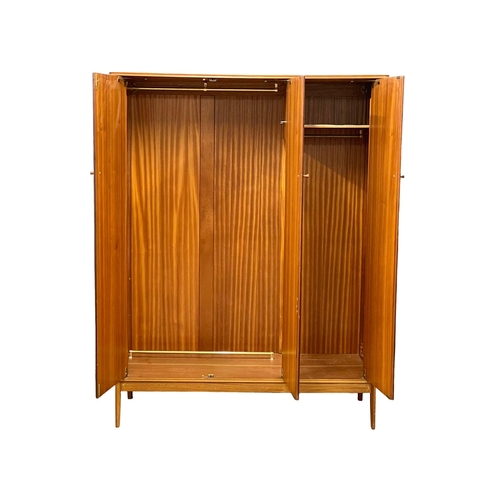 914 - A Mid Century teak 3 door wardrobe designed by Peter hayward for Vanson. 1960. 141x60x184.5cm (3)