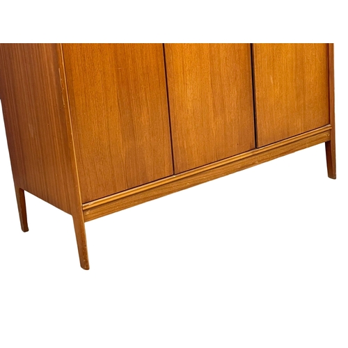 914 - A Mid Century teak 3 door wardrobe designed by Peter hayward for Vanson. 1960. 141x60x184.5cm (3)