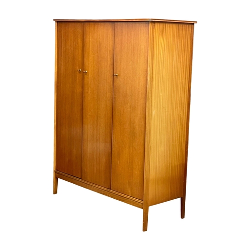 914 - A Mid Century teak 3 door wardrobe designed by Peter hayward for Vanson. 1960. 141x60x184.5cm (3)