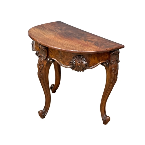 920 - A Victorian Burr Walnut and mahogany Demi Lune hall table on cabriole legs. Circa 1860. 78x50.5x68cm... 