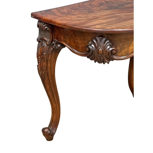 920 - A Victorian Burr Walnut and mahogany Demi Lune hall table on cabriole legs. Circa 1860. 78x50.5x68cm... 