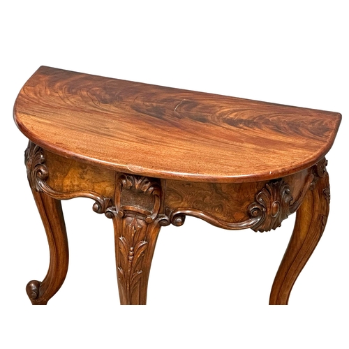 920 - A Victorian Burr Walnut and mahogany Demi Lune hall table on cabriole legs. Circa 1860. 78x50.5x68cm... 