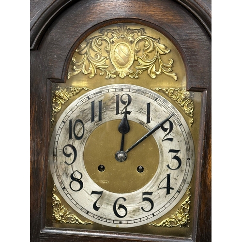 928 - An early 20th century oak long case clock with brass and pendulum. 197cm (4)