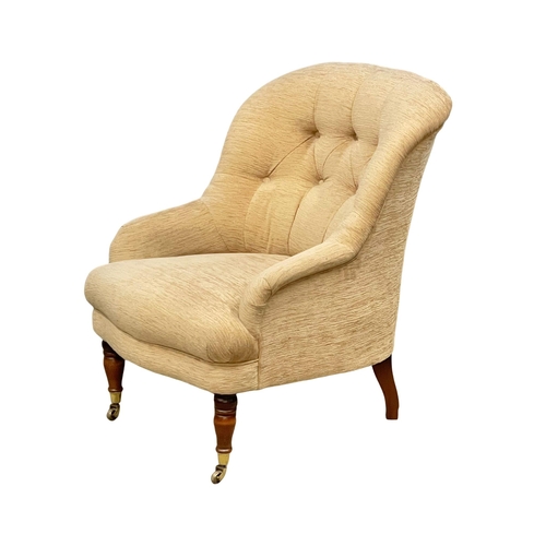 930 - A Victorian style deep button back armchair on brass cup casters. 67x88x85.5cm (1)