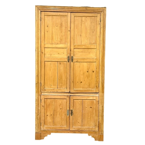 939 - A large late George III pine corner cabinet with fitted shelves and architectural interior. Circa 18... 