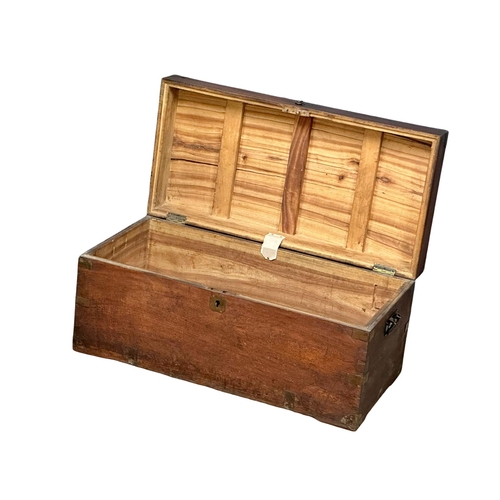 94 - A Victorian camphorwood campaign trunk. 84x41x38cm