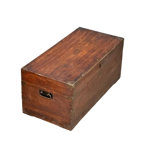 94 - A Victorian camphorwood campaign trunk. 84x41x38cm