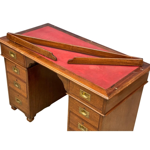 941 - A Victorian mahogany gallery back campaign desk with leather top. (13)