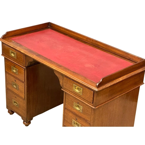 941 - A Victorian mahogany gallery back campaign desk with leather top. (13)