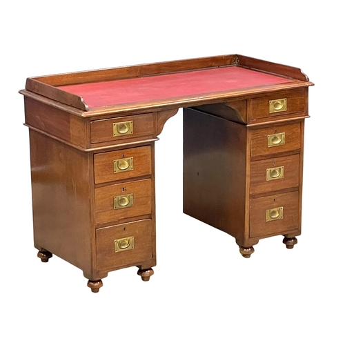 941 - A Victorian mahogany gallery back campaign desk with leather top. (13)