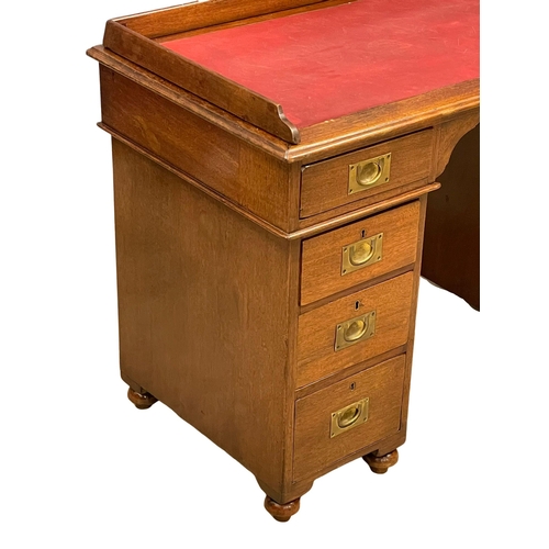 941 - A Victorian mahogany gallery back campaign desk with leather top. (13)