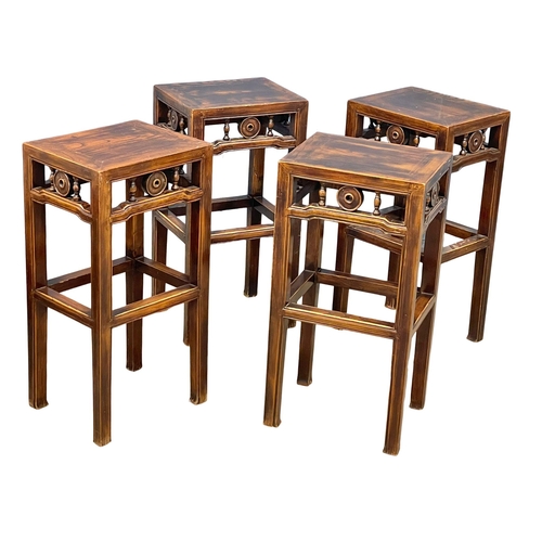 945 - A vintage Chinese Elm table and 4 stools. 100x65x113cm (12)