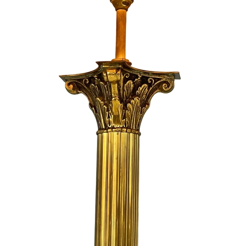 954 - A vintage brass standard lamp with Corinthian style column on lion paw feet. 167cm (3)