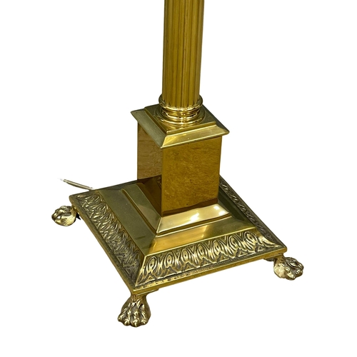 954 - A vintage brass standard lamp with Corinthian style column on lion paw feet. 167cm (3)