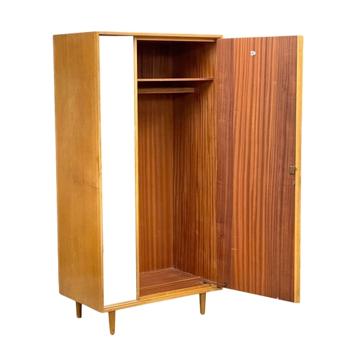 957 - A Mid Century oak ‘C Range’ Mid Century wardrobe designed by John & Sylvia Reid for Stag. 1960. 91.5... 