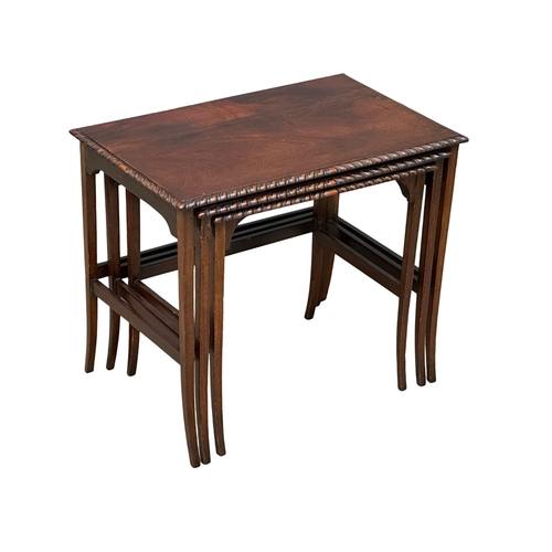 961 - A 1920’s mahogany nest of tables with gadrooning moulding on splayed feet. (8)