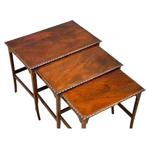 961 - A 1920’s mahogany nest of tables with gadrooning moulding on splayed feet. (8)