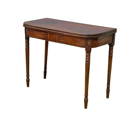 977 - A George IV inlaid mahogany turnover tea table. Circa 1820. 91x45x72.5cm (3)