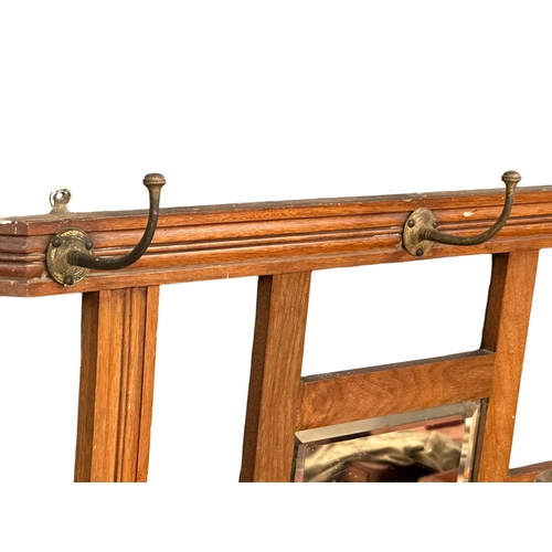 99 - A late Victorian wall hanging hat and coat rack with bevelled mirror. Circa 1890-1900. 76x55cm