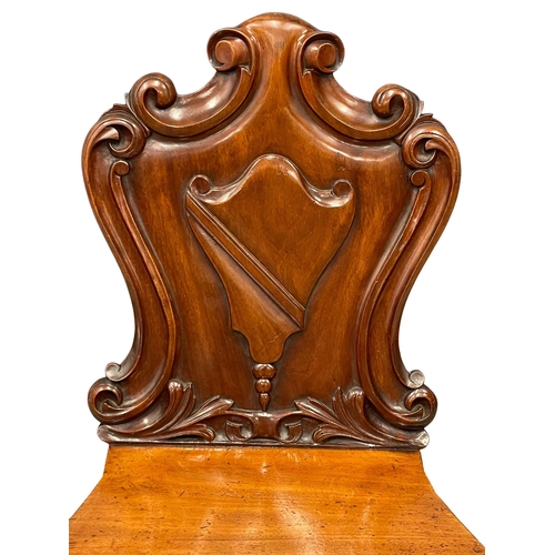 995 - A Victorian mahogany hall chair. (2)