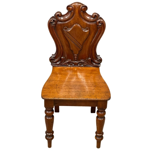 995 - A Victorian mahogany hall chair. (2)