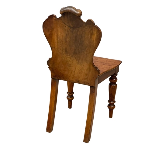 995 - A Victorian mahogany hall chair. (2)