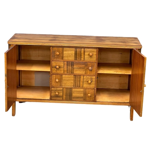 996 - A Mid Century Walnut sideboard with 4 drawers and 2 cupboards. 1950’s. 138x47.5x82cm