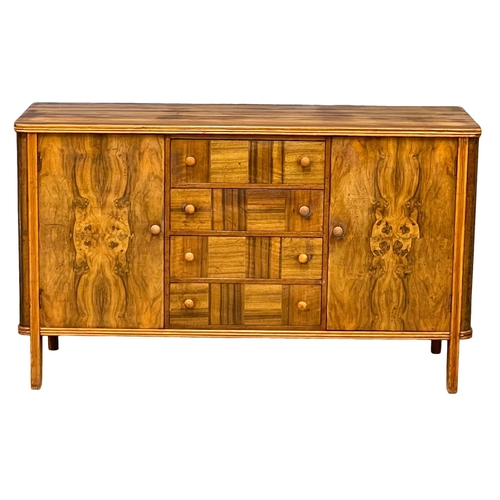 996 - A Mid Century Walnut sideboard with 4 drawers and 2 cupboards. 1950’s. 138x47.5x82cm