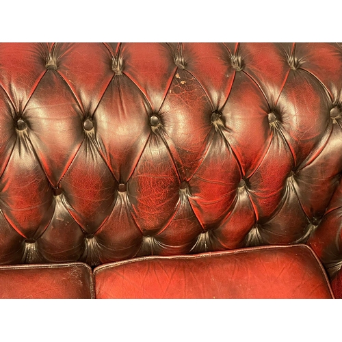 1202 - An ox-blood deep button leather 3 seater sofa. 197cm. (10)