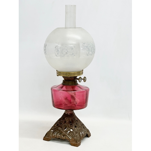 2 - A late Victorian brass oil lamp with Ruby Glass bowl. 55cm