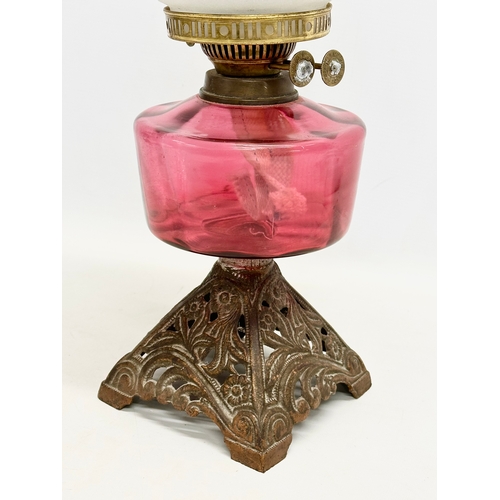 2 - A late Victorian brass oil lamp with Ruby Glass bowl. 55cm