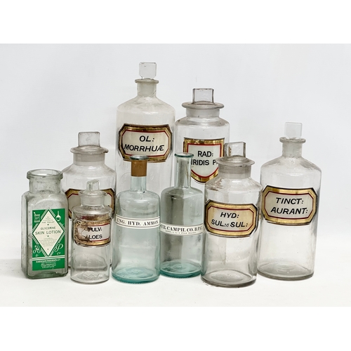 6 - A collection of late Victorian/Edwardian chemist bottles. Pair of largest 26cm. 3 measuring 23cm