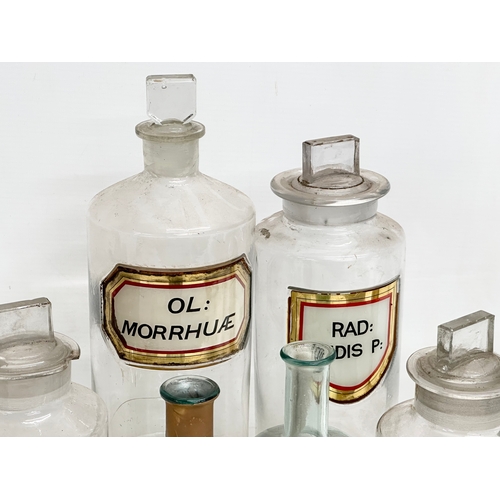 6 - A collection of late Victorian/Edwardian chemist bottles. Pair of largest 26cm. 3 measuring 23cm