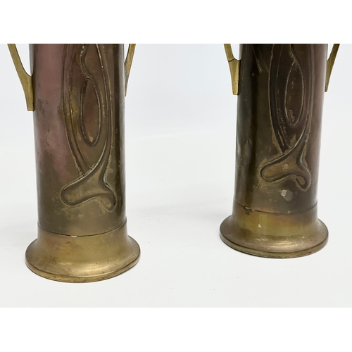 46 - A pair of early 20th century Art Nouveau copper and brass vases by Beldray. 31cm