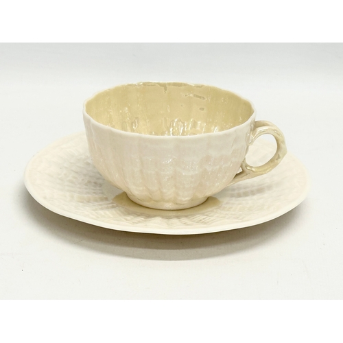 50 - A late 19th century first period Belleek pottery ‘Tridacna’ cup and saucer. Circa 1863-1891.