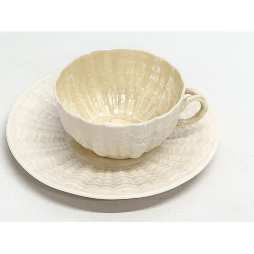 50 - A late 19th century first period Belleek pottery ‘Tridacna’ cup and saucer. Circa 1863-1891.