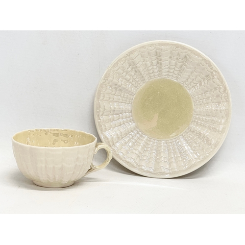 50 - A late 19th century first period Belleek pottery ‘Tridacna’ cup and saucer. Circa 1863-1891.