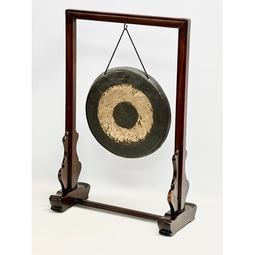 58 - A late 19th/early 20th century Chinese brass gong in a later rosewood frame. 46x21x68cm