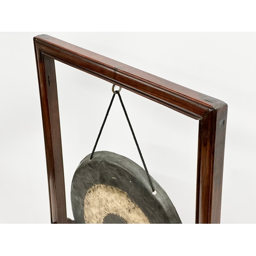 58 - A late 19th/early 20th century Chinese brass gong in a later rosewood frame. 46x21x68cm