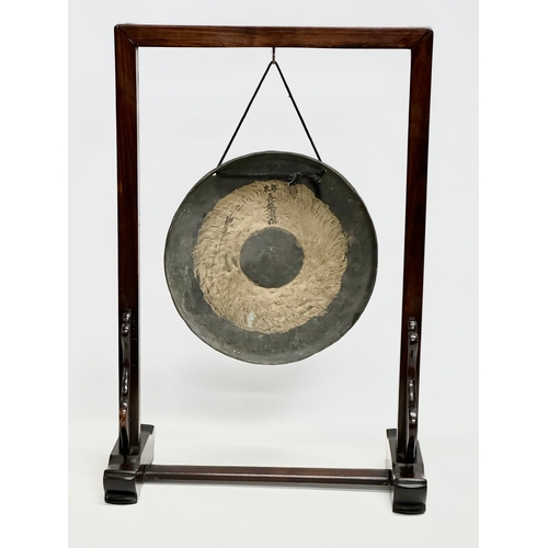 58 - A late 19th/early 20th century Chinese brass gong in a later rosewood frame. 46x21x68cm