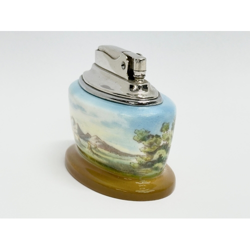 72 - A Mintons bone china table lighter signed A. Holland. By Ronson.