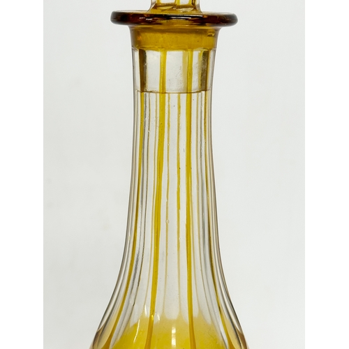 36 - A tall early 20th century Bohemian amber stained and cut glass decanter with engraved flower and gra... 