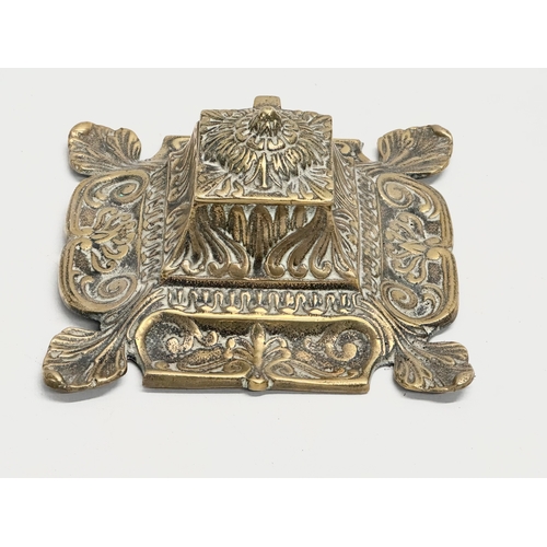 79 - An early 20th century ornate brass inkwell with liner. 16x16x8cm