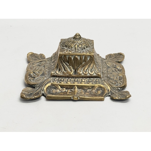 79 - An early 20th century ornate brass inkwell with liner. 16x16x8cm