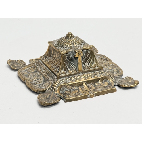 79 - An early 20th century ornate brass inkwell with liner. 16x16x8cm