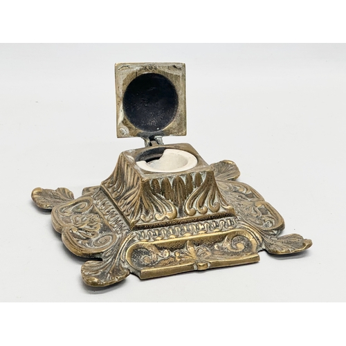 79 - An early 20th century ornate brass inkwell with liner. 16x16x8cm