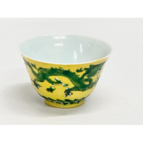 16 - A 19th century Chinese emperor Tongzhi (1856-1875) yellow ground porcelain rice bowl with green enam... 