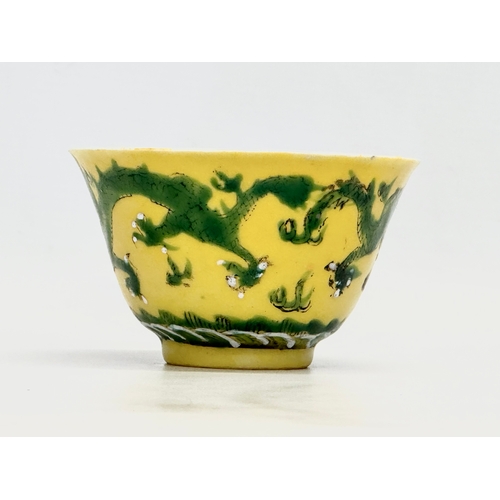 16 - A 19th century Chinese emperor Tongzhi (1856-1875) yellow ground porcelain rice bowl with green enam... 